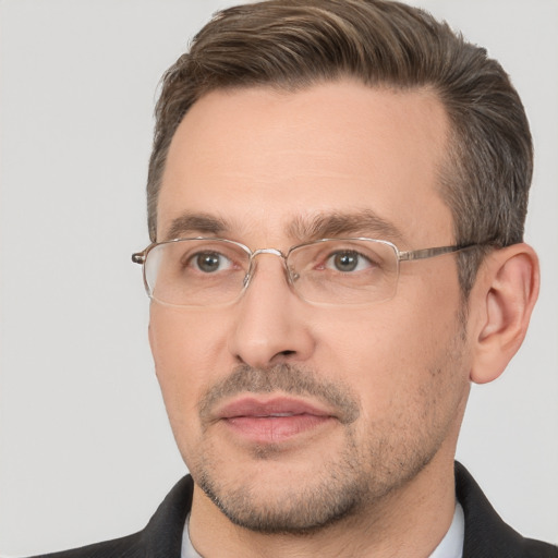 Joyful white adult male with short  brown hair and brown eyes