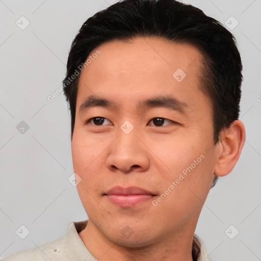 Joyful asian young-adult male with short  brown hair and brown eyes