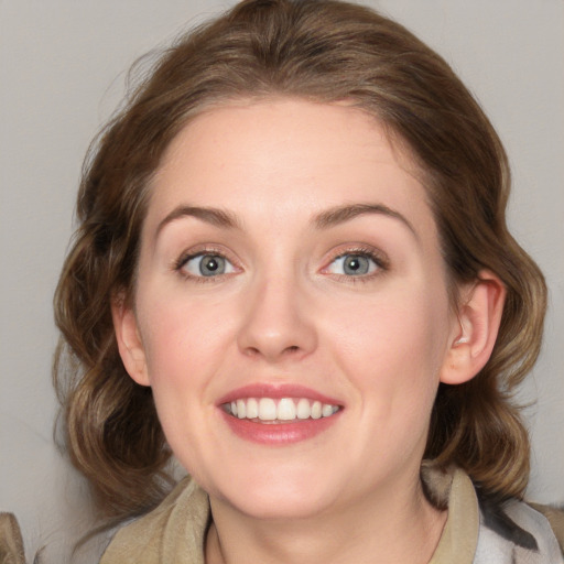 Joyful white young-adult female with medium  brown hair and blue eyes