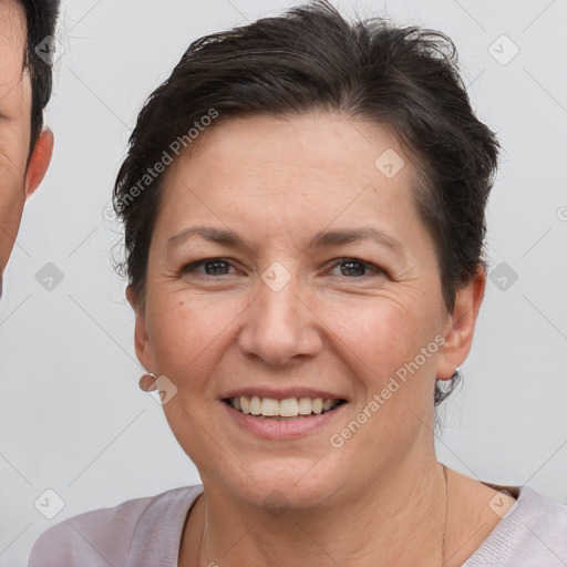 Joyful white adult female with short  brown hair and brown eyes