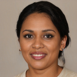 Joyful black young-adult female with medium  brown hair and brown eyes