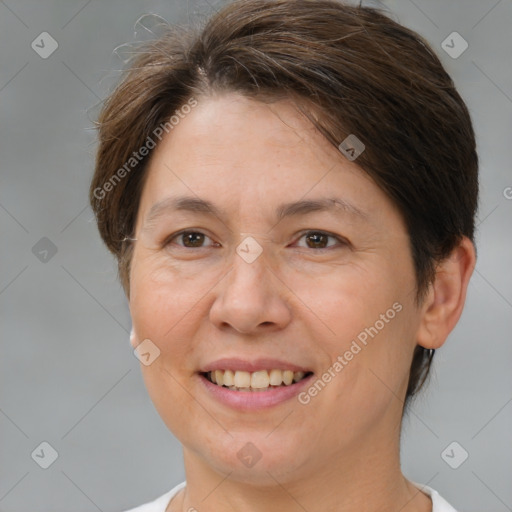 Joyful white adult female with short  brown hair and brown eyes