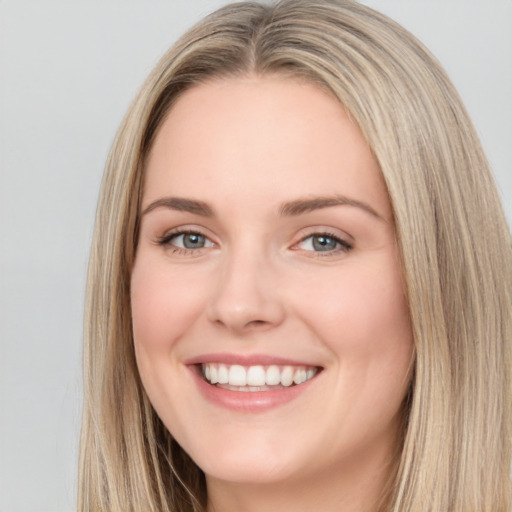 Joyful white young-adult female with long  brown hair and blue eyes