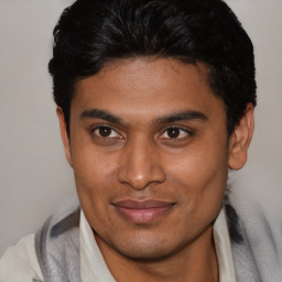 Joyful latino young-adult male with short  brown hair and brown eyes