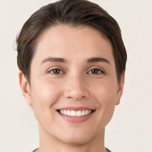 Joyful white young-adult female with short  brown hair and brown eyes