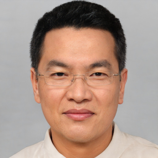 Joyful white adult male with short  black hair and brown eyes