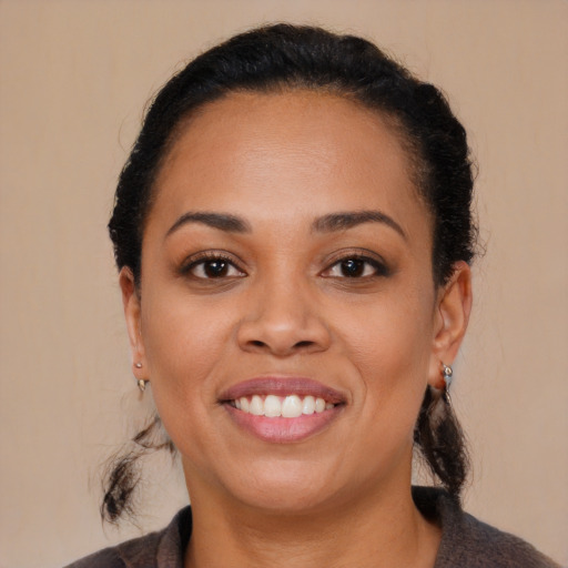 Joyful black young-adult female with medium  brown hair and brown eyes