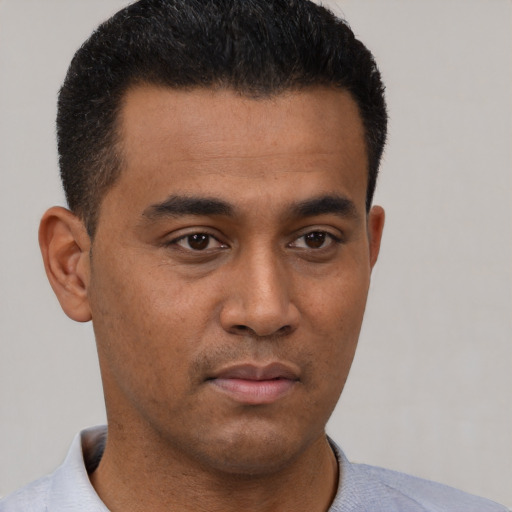 Neutral latino young-adult male with short  brown hair and brown eyes