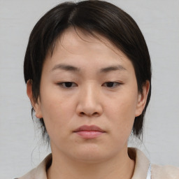 Neutral asian young-adult female with medium  brown hair and brown eyes