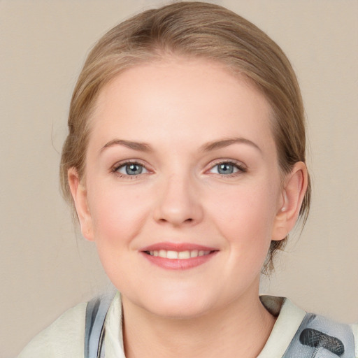 Joyful white young-adult female with medium  brown hair and blue eyes