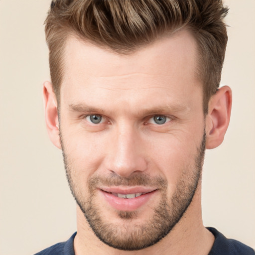 Joyful white young-adult male with short  brown hair and grey eyes