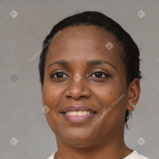 Joyful black adult female with short  brown hair and brown eyes