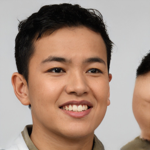 Joyful asian young-adult male with short  brown hair and brown eyes