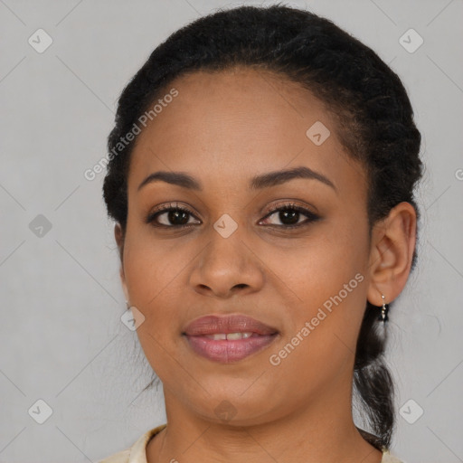 Joyful black young-adult female with long  brown hair and brown eyes