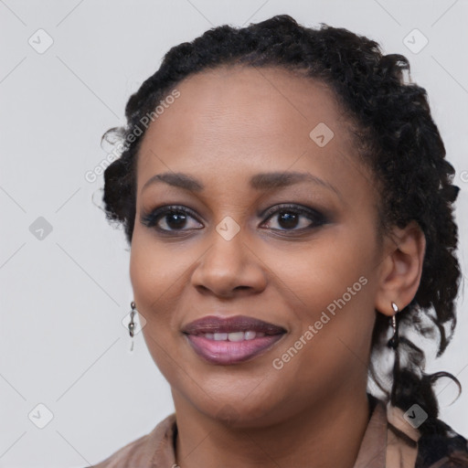 Joyful black young-adult female with long  black hair and brown eyes