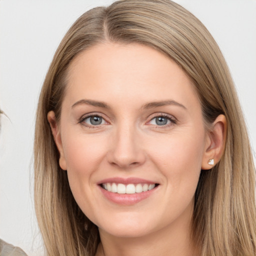 Joyful white young-adult female with long  brown hair and grey eyes