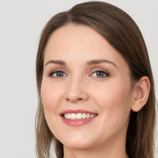 Joyful white young-adult female with long  brown hair and grey eyes