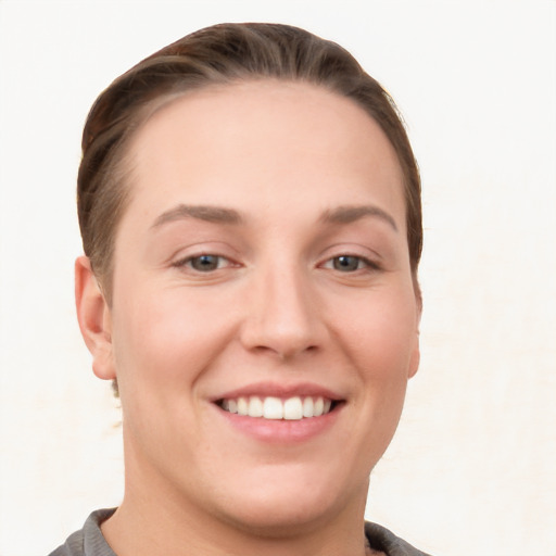 Joyful white young-adult female with short  brown hair and grey eyes