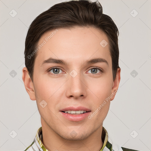 Joyful white young-adult male with short  brown hair and grey eyes