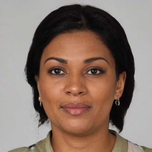 Joyful black young-adult female with medium  black hair and brown eyes