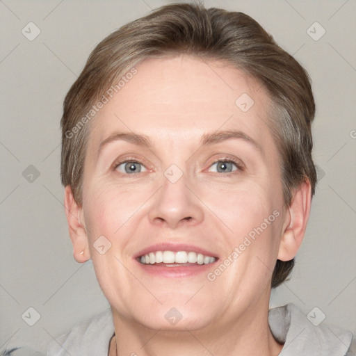 Joyful white adult female with short  brown hair and grey eyes