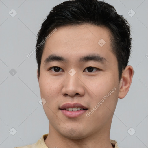 Joyful asian young-adult male with short  black hair and brown eyes