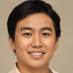 Joyful asian young-adult male with short  brown hair and brown eyes