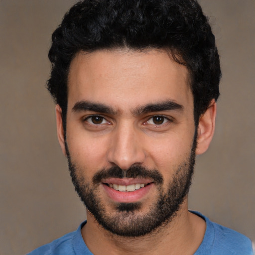 Joyful white young-adult male with short  black hair and brown eyes
