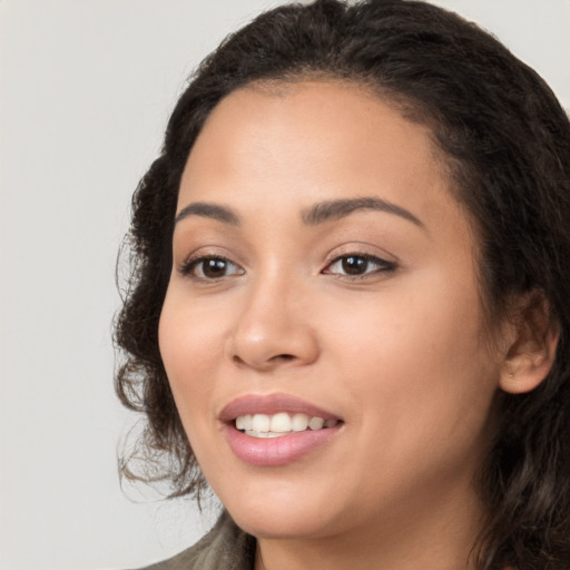 Joyful white young-adult female with long  black hair and brown eyes