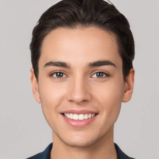 Joyful white young-adult male with short  brown hair and brown eyes