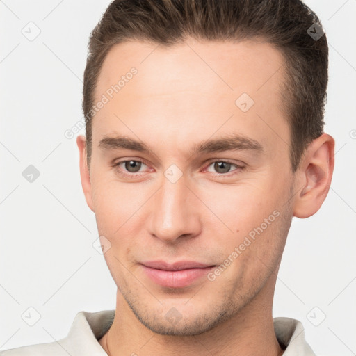 Joyful white young-adult male with short  brown hair and brown eyes