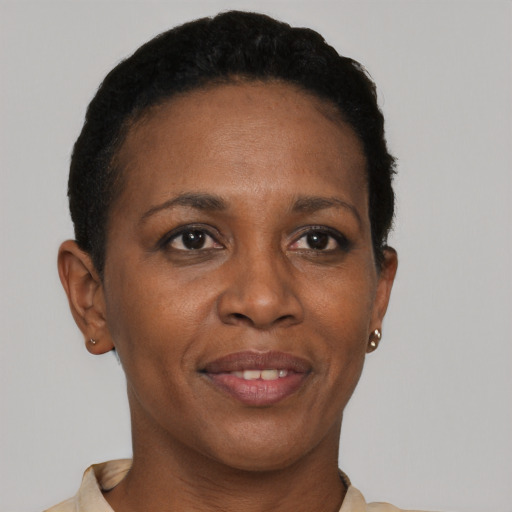 Joyful black adult female with short  black hair and brown eyes