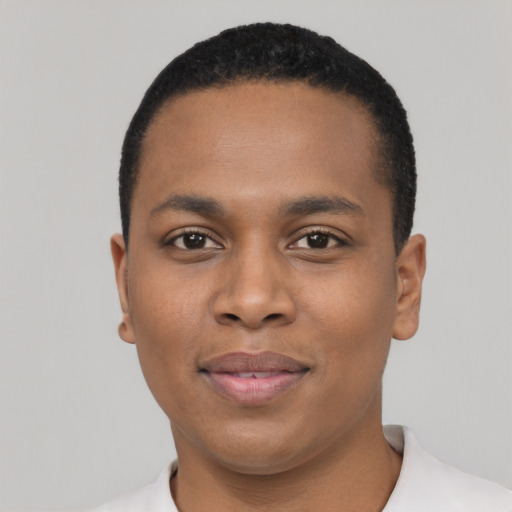 Joyful black young-adult male with short  black hair and brown eyes