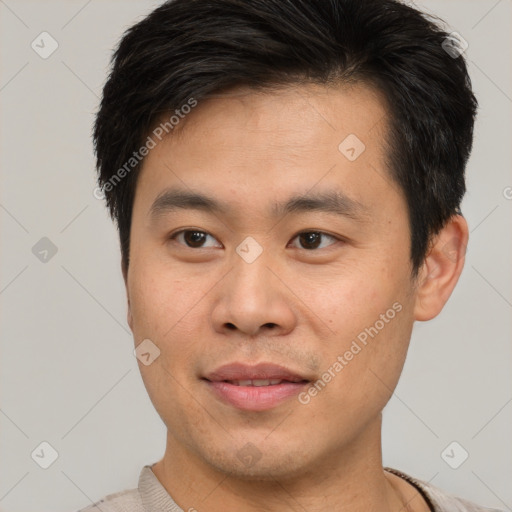 Joyful asian young-adult male with short  brown hair and brown eyes