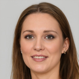 Joyful white young-adult female with long  brown hair and grey eyes