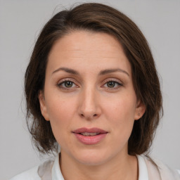 Joyful white adult female with medium  brown hair and brown eyes