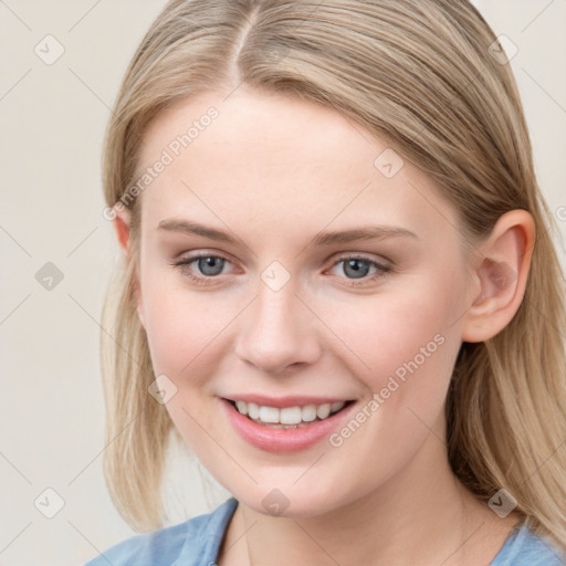 Joyful white young-adult female with long  brown hair and blue eyes