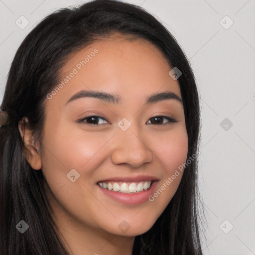 Joyful latino young-adult female with long  brown hair and brown eyes