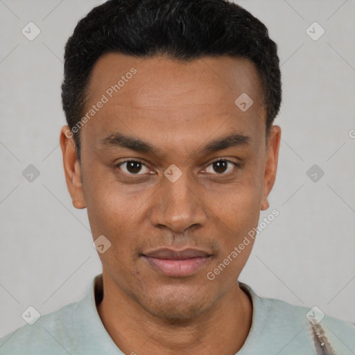 Joyful black young-adult male with short  black hair and brown eyes