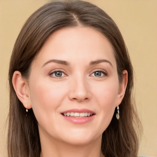 Joyful white young-adult female with long  brown hair and grey eyes