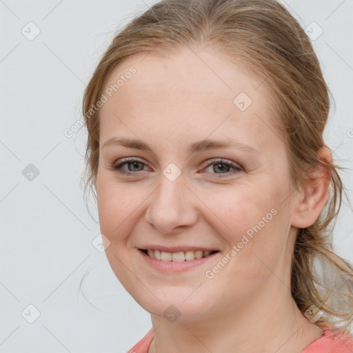 Joyful white young-adult female with medium  brown hair and blue eyes