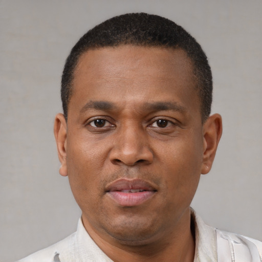 Joyful latino adult male with short  black hair and brown eyes