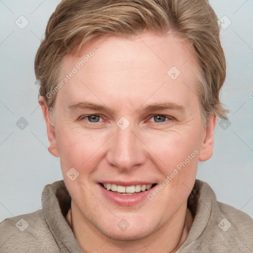 Joyful white young-adult female with short  brown hair and blue eyes