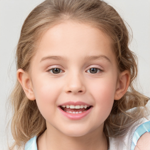 Joyful white child female with medium  brown hair and grey eyes