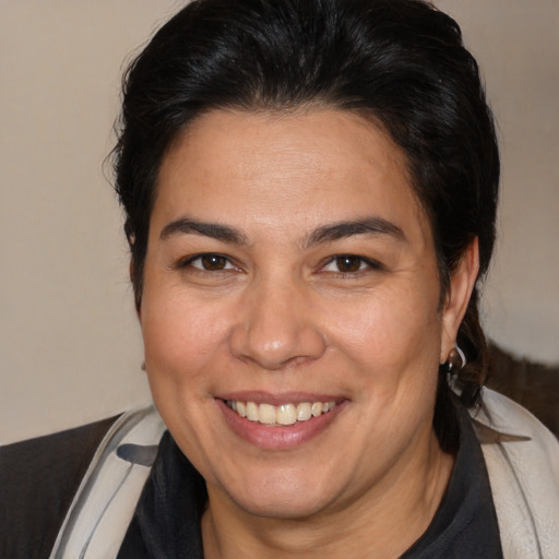 Joyful white adult female with medium  brown hair and brown eyes