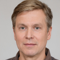 Joyful white adult male with short  brown hair and grey eyes