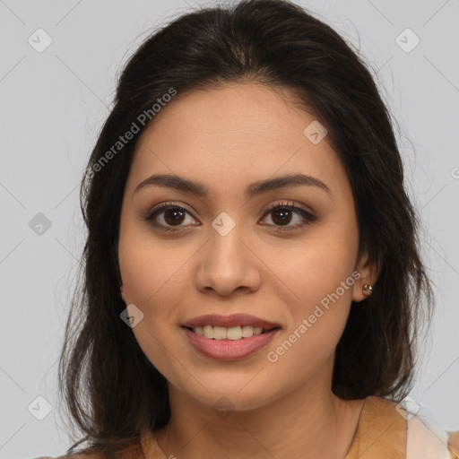 Joyful latino young-adult female with long  brown hair and brown eyes