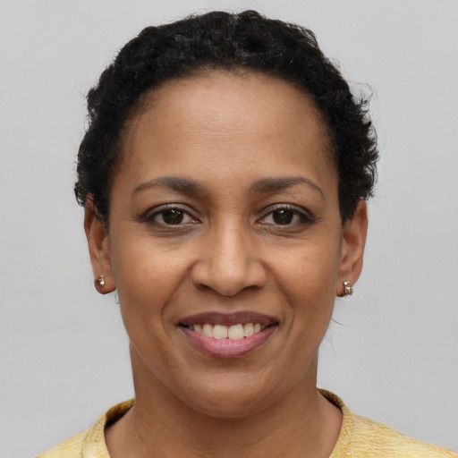 Joyful latino adult female with short  brown hair and brown eyes
