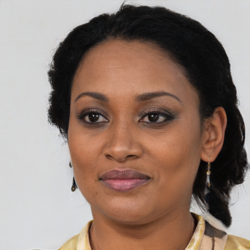 Joyful black adult female with medium  black hair and brown eyes
