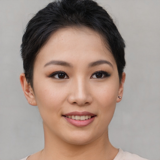 Joyful asian young-adult female with short  brown hair and brown eyes